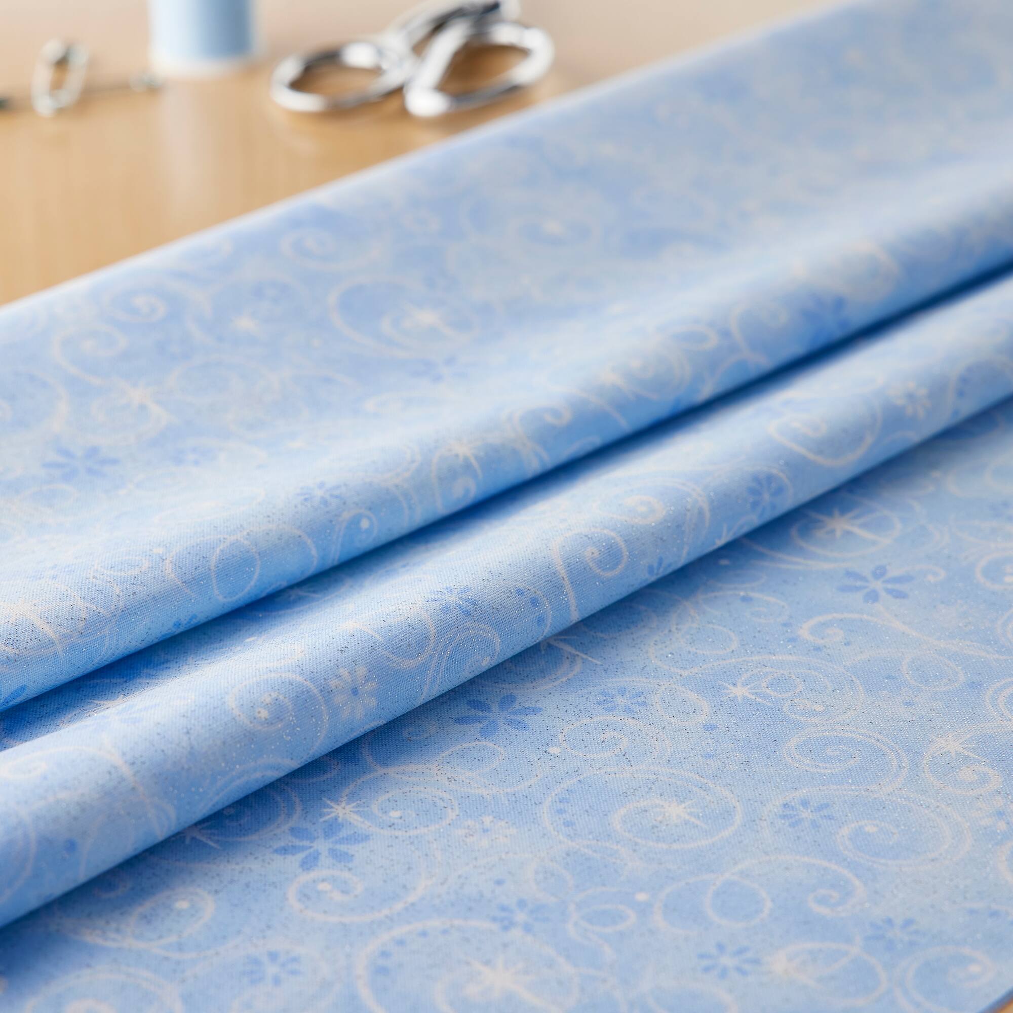 Fabric Traditions Swirls on Light Blue Glitter Cotton Fabric